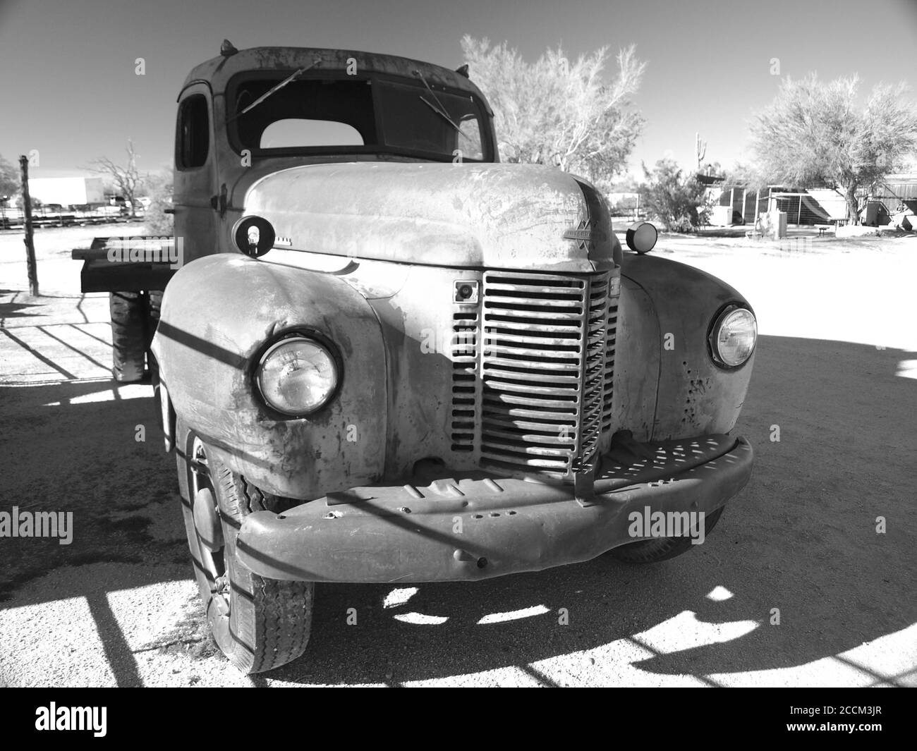Black and white  image of an old International flatbed truck near Scottsdale, Arizona, USA.  Derelict truck is forlorn sitting in the desert. Stock Photo