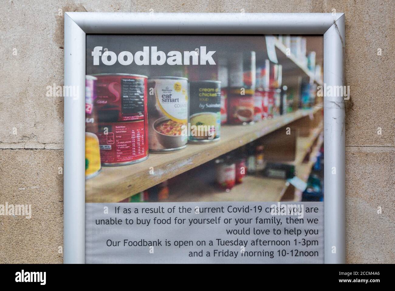 A sign outside a food bank showing the opening hours Stock Photo Alamy