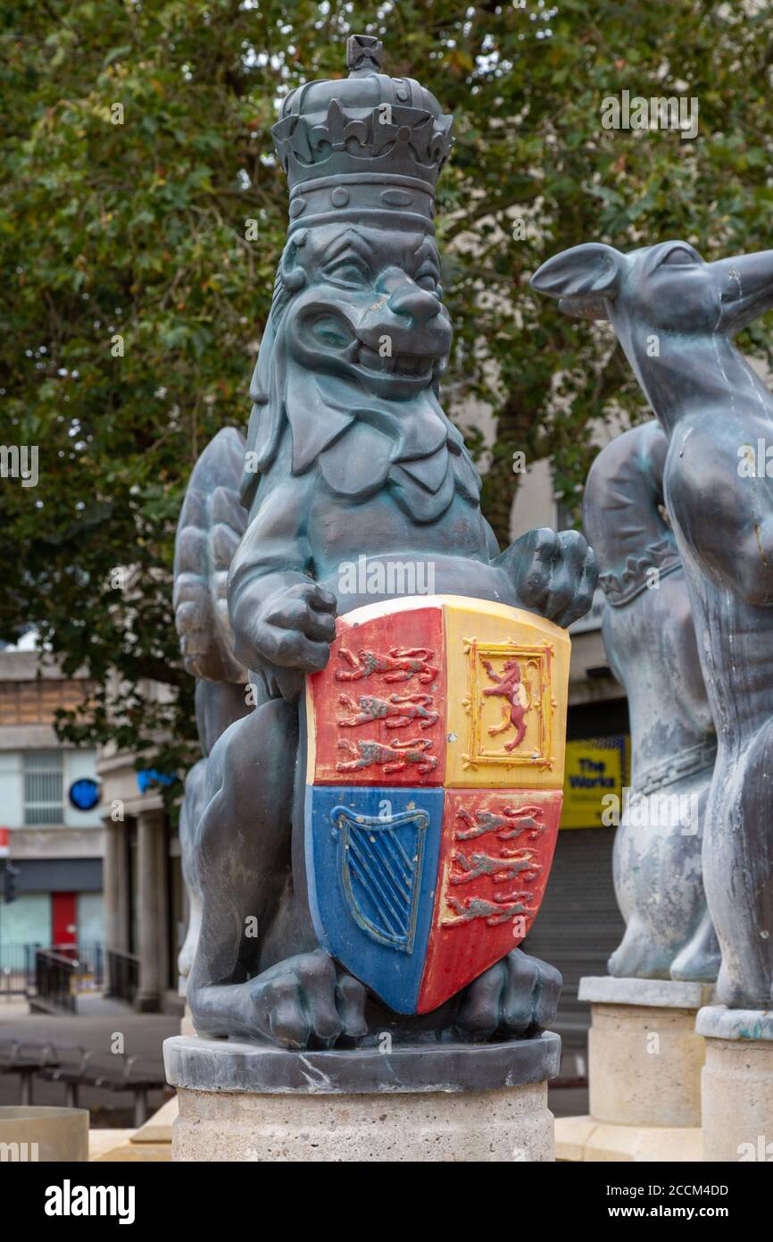 A lion statue wearing a crown and holding a coat of arms as part of the queens silver jubilee statue in Portsmouth city centre Stock Photo