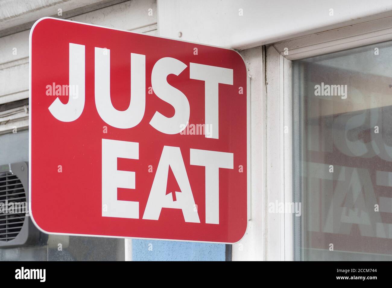Just Eat sign outside a takeaway restaurant in Plymouth, Devon. J/E is a food delivery service