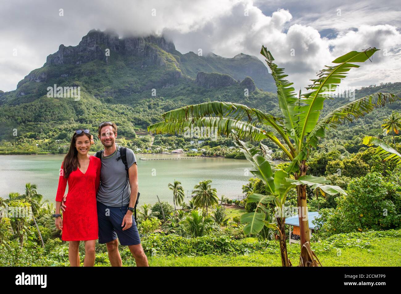 Bora Bora luxury cruise travel vacation tourists couple in front of Mt Otemanu in French Polynesia. Tahiti getaway holiday people visiting the island Stock Photo