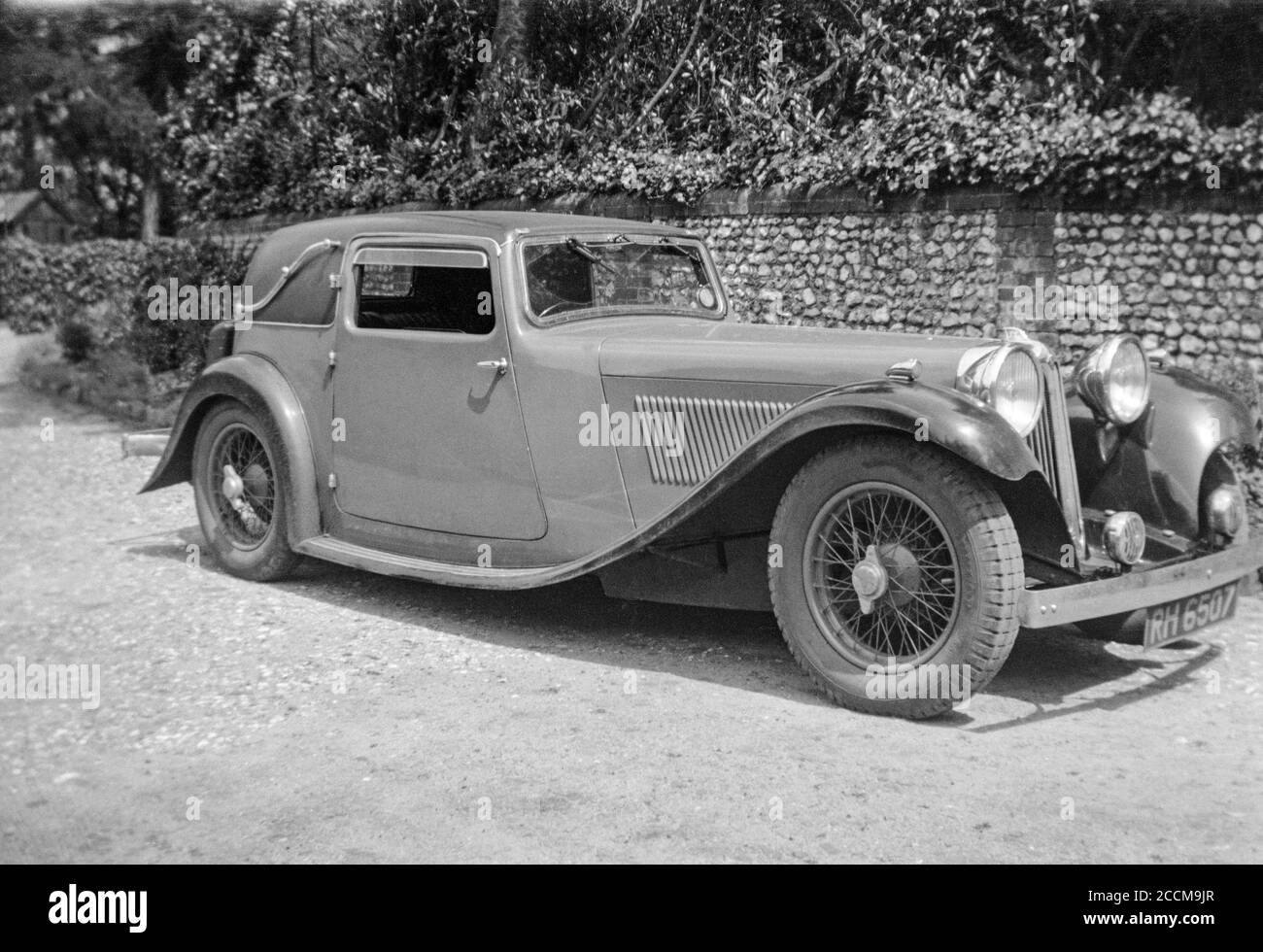 A vintage 1930s black and white photograph of a British Jaguar SS II Coupe Sports car. Registration number RH 6507. Stock Photo