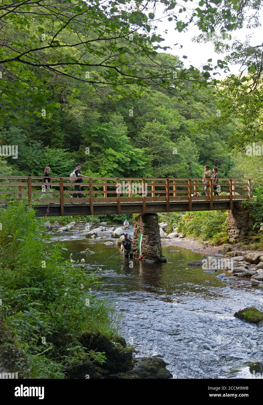 Fishermen and walkers at the bridge where Watersmeet on the east Lyn River, Lynmouth in North Devon Stock Photo