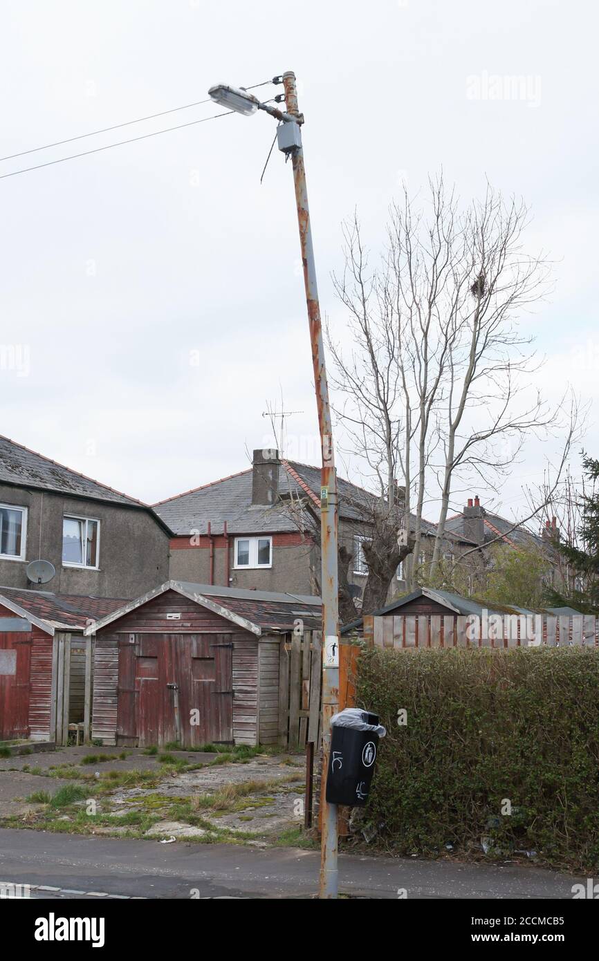 Rusty and bent street light column or lamp post in Glasgow, Scotland. Poorly maintained, council, local authority, lack of funds, budget cuts Stock Photo