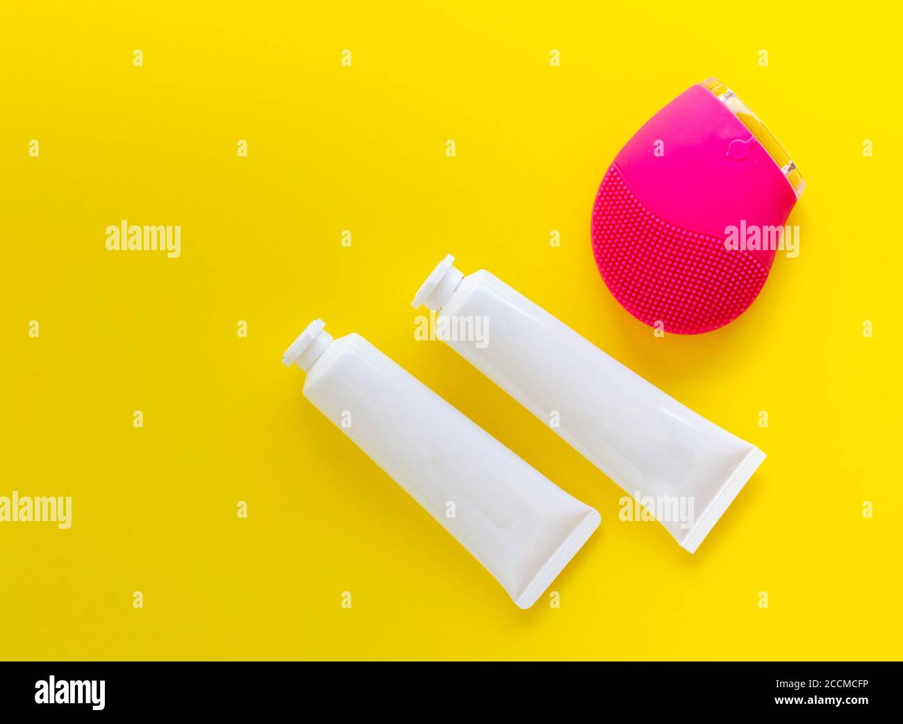 cosmetic mockup for skincare products with pink facial cleansing brush Stock Photo