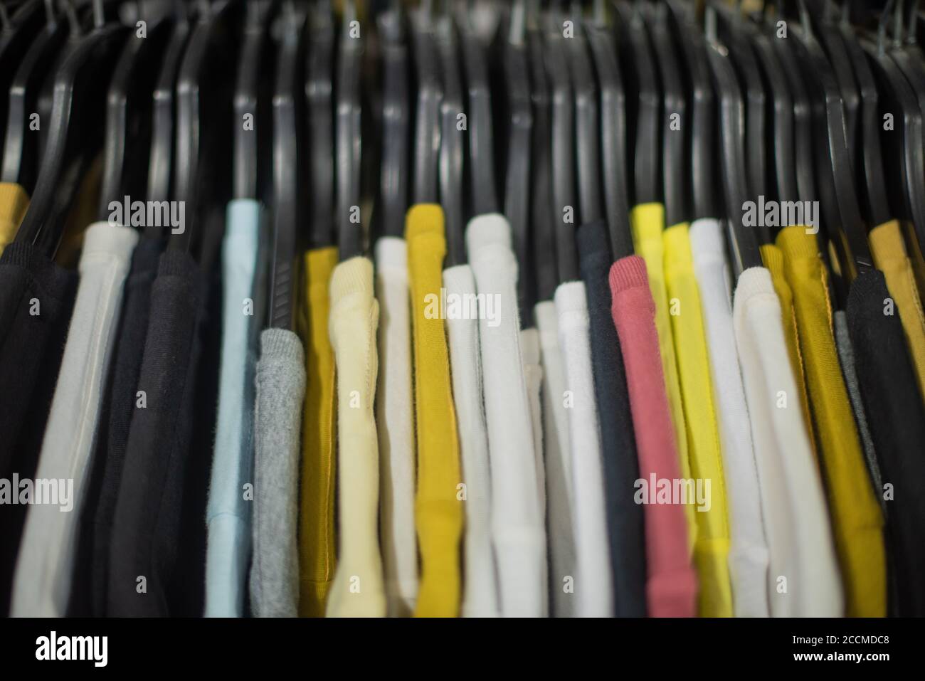 T shirts lined in a row on rack Stock Photo