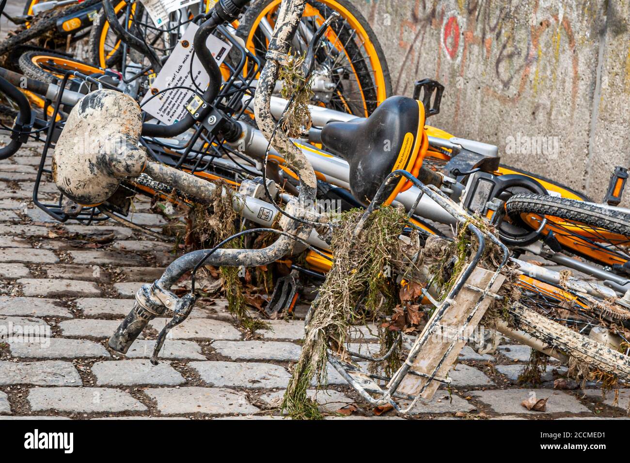 Bicycles for rent are disposed in the river Isar in Munich, Germany Stock Photo