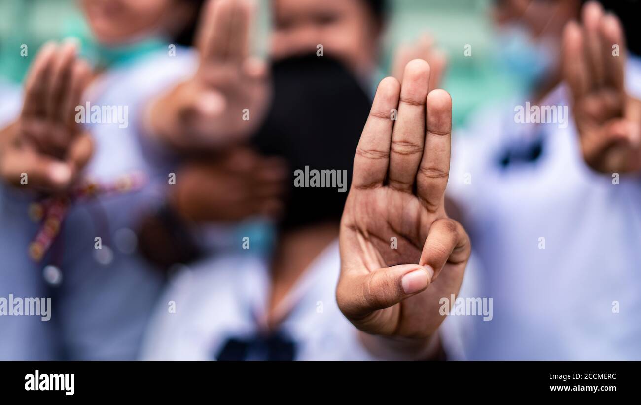 Students girl showing three finger salute in school.16:9 style Stock Photo