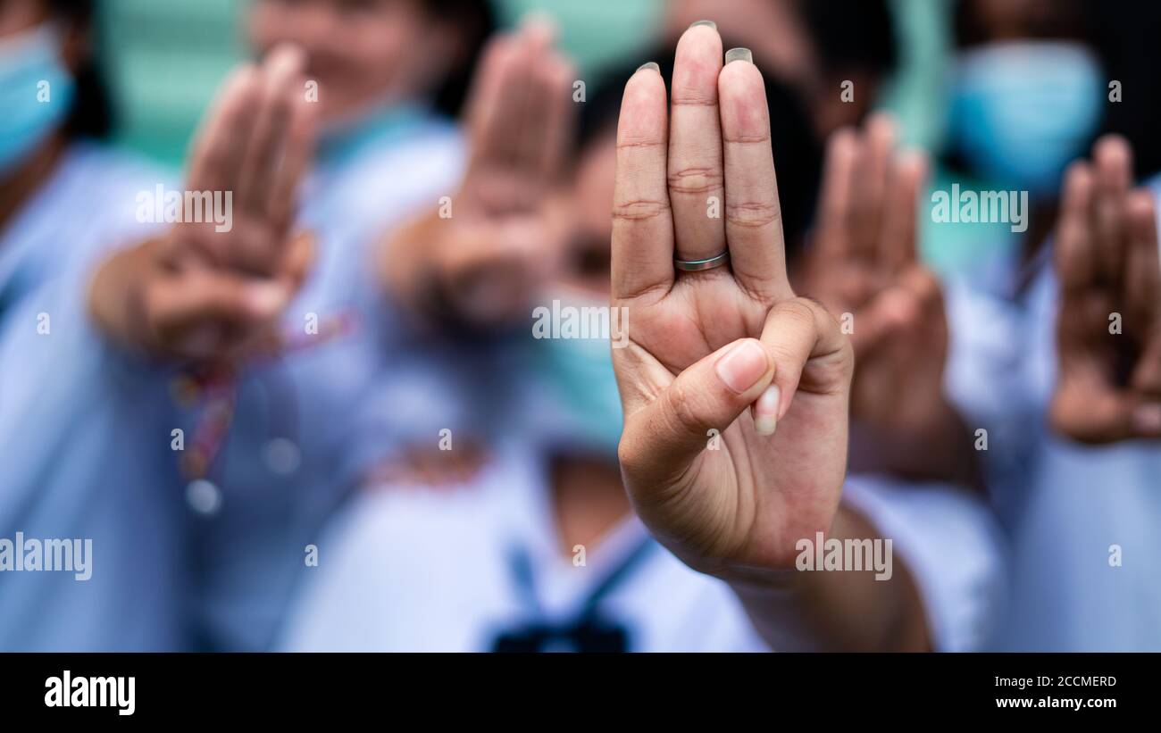 Students girl showing three finger salute in school.16:9 style Stock Photo
