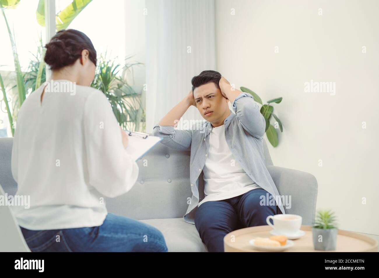 Psychotherapist working with young man in office. Stock Photo