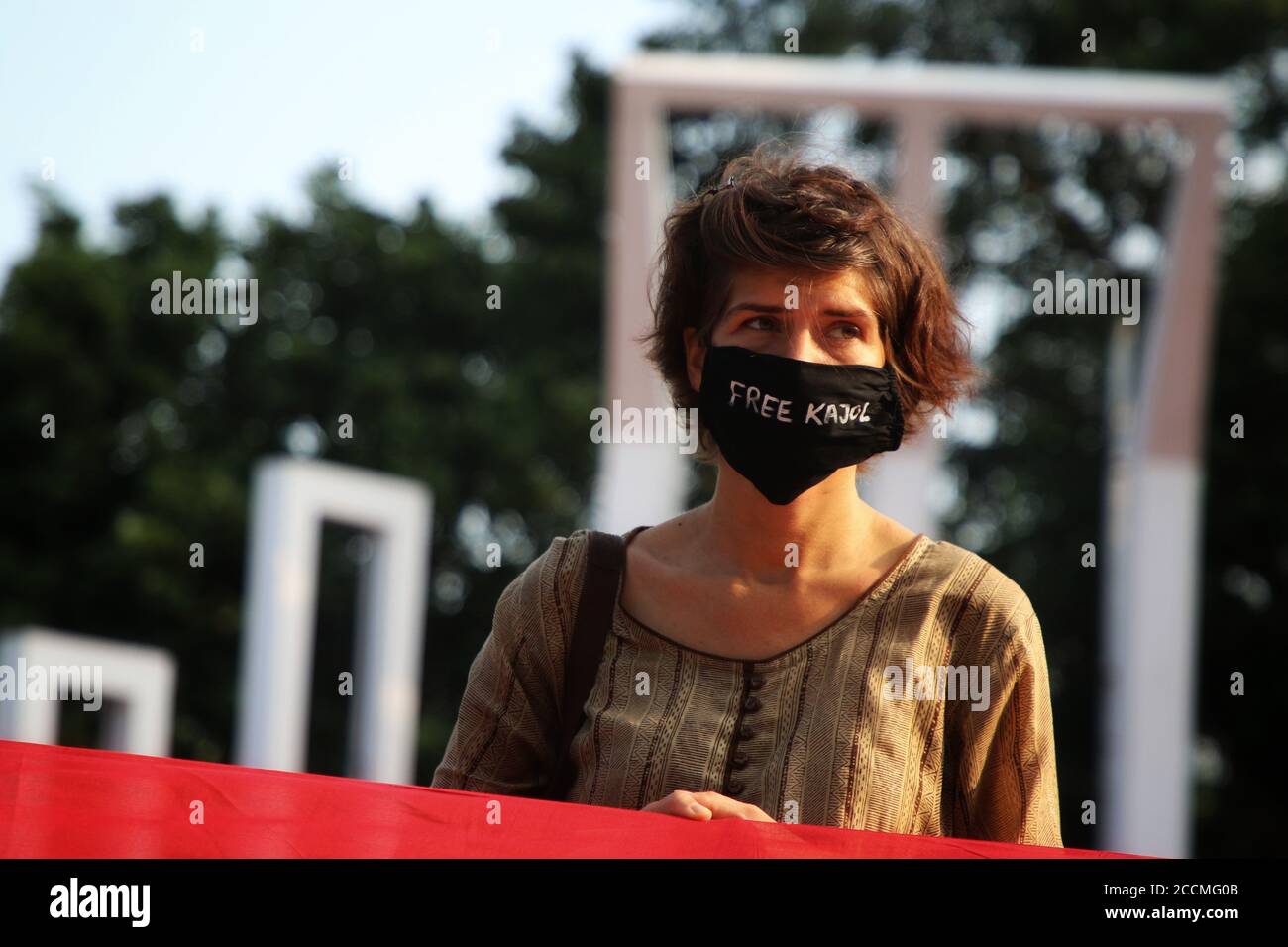 A protester is seen wearing a facemask with writings free Kajol (Photojournalist Shafiqul Islam Kajol who was sent to jail under section 54 of the Code of Criminal Procedure), during the demonstration.Activists and artists protest against the persecution and arrests of fellow artists and journalists under the draconian Digital Security Act, during the COVID-19 pandemic. Stock Photo