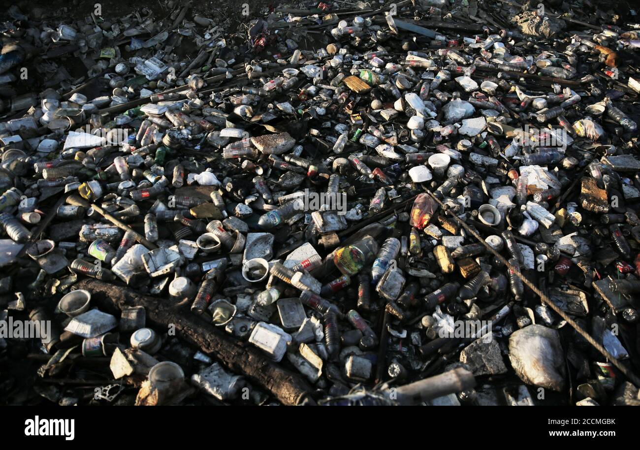 A pile of garbage polluting the coast.Plastic waste that has accumulated around the coast endangers marine life and local residents. Stock Photo