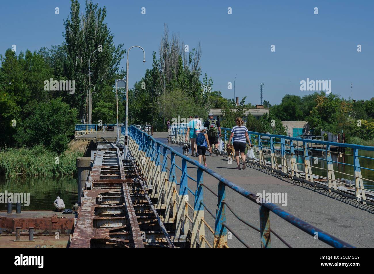 Nikolaev, Ukraine, August 17: Pontoon bridge over the Ingul river. People and pets are crossing the footbridge. Summer day. City life Stock Photo