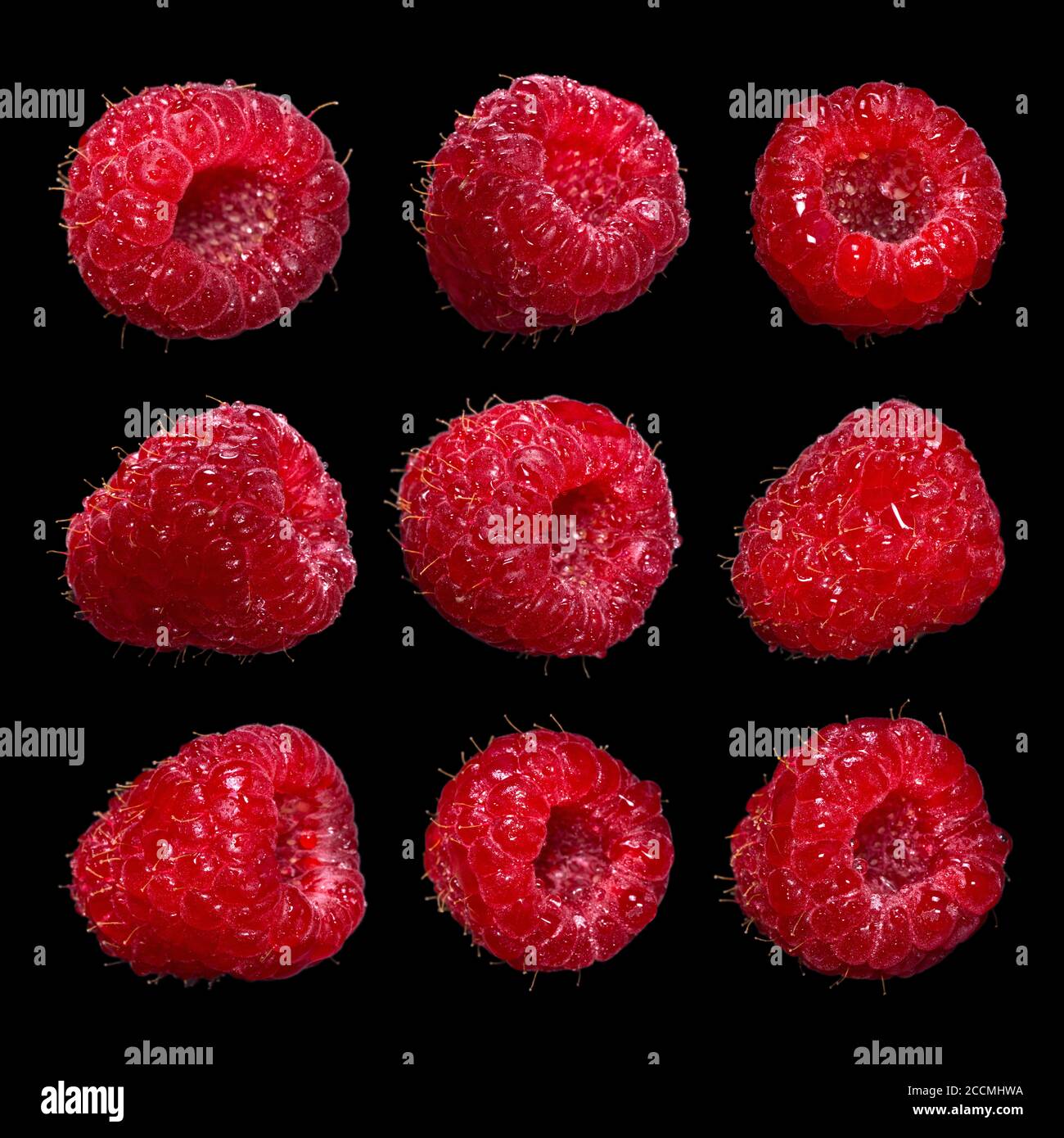 Large set of fresh ripe raspberry isolated on a black background. Macro ...
