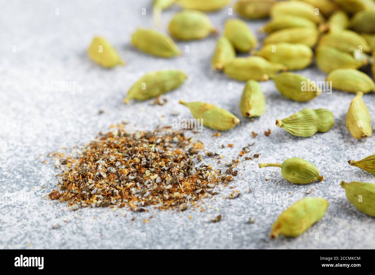 Ground cardamom seeds and whole pods closeup. Seasonings and spices
