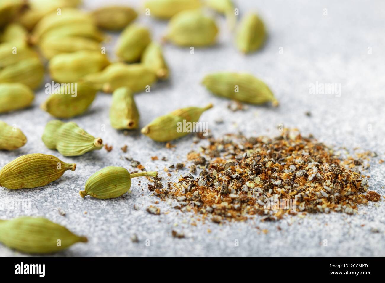 Ground cardamom seeds and whole pods closeup. Seasonings and spices