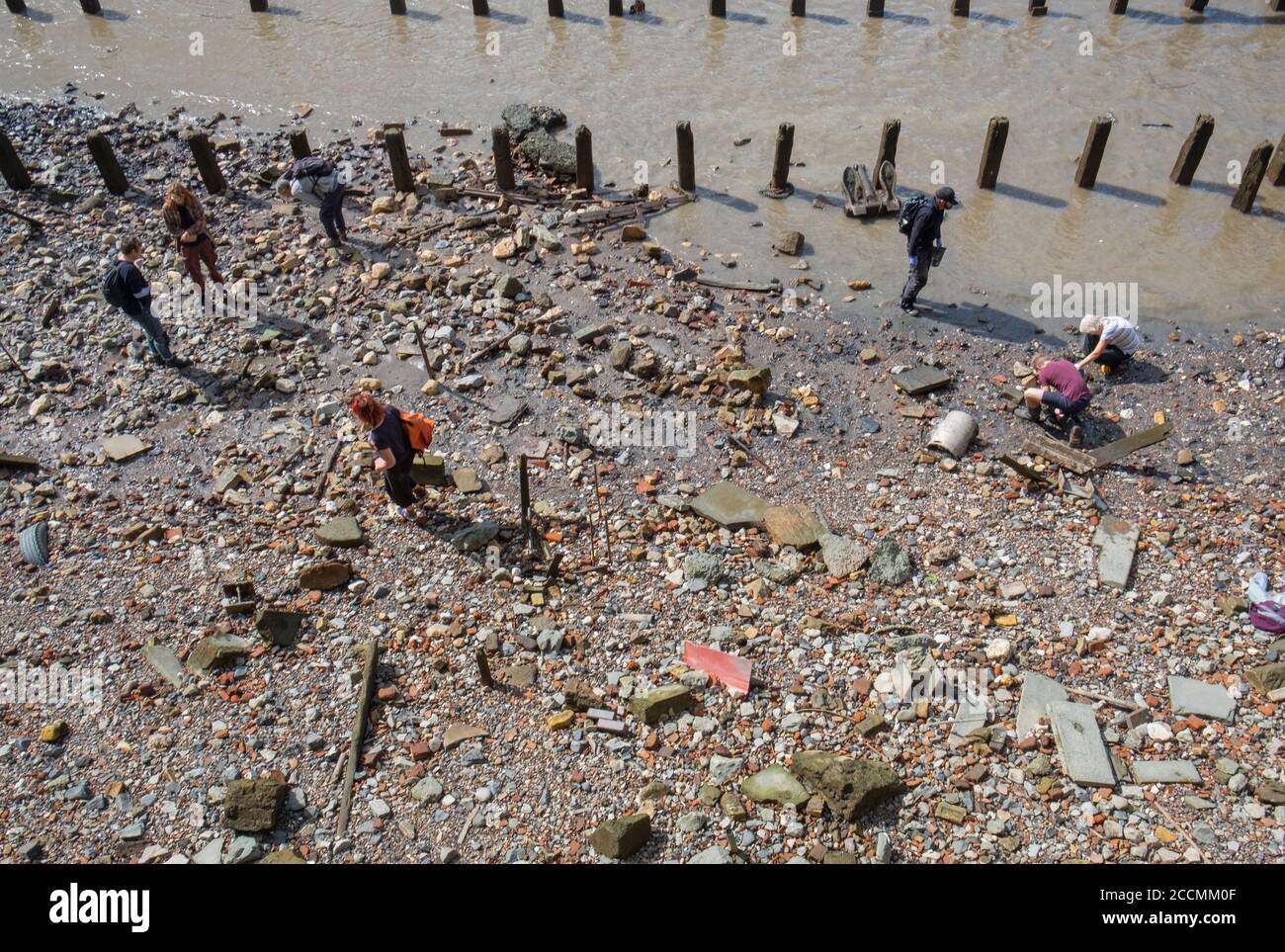 'Mud Larkers' searching the Thames shore at low tide Stock Photo