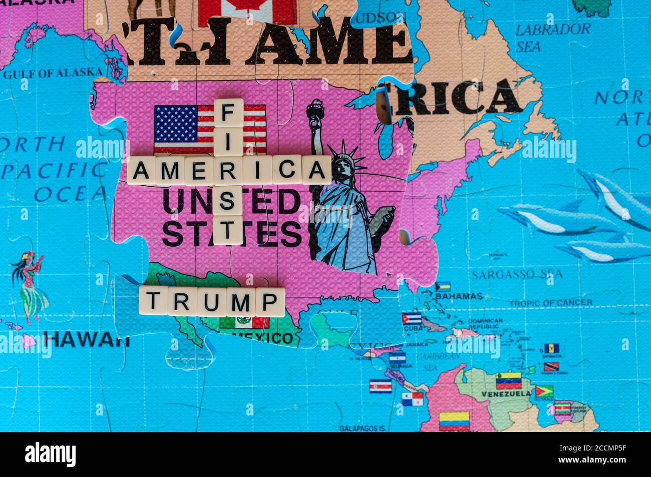 America first, in words and images on a 3D world map puzzle. An iconic image of  Trump's  approach to geopolitics. Popular right-wing stance in USA. Stock Photo
