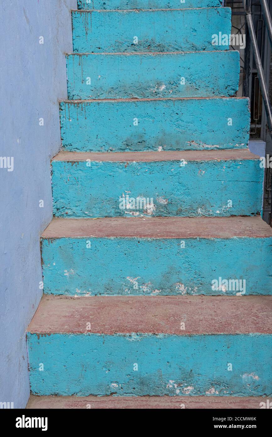 Well-worn blue stairs define the entrance to a Lima residence Stock