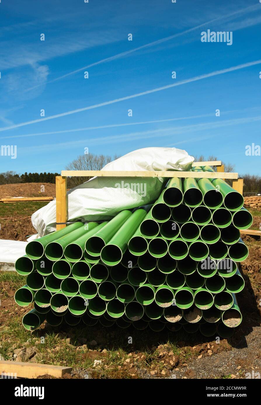 Green drainage pipes on ground which has been cleared for new housing