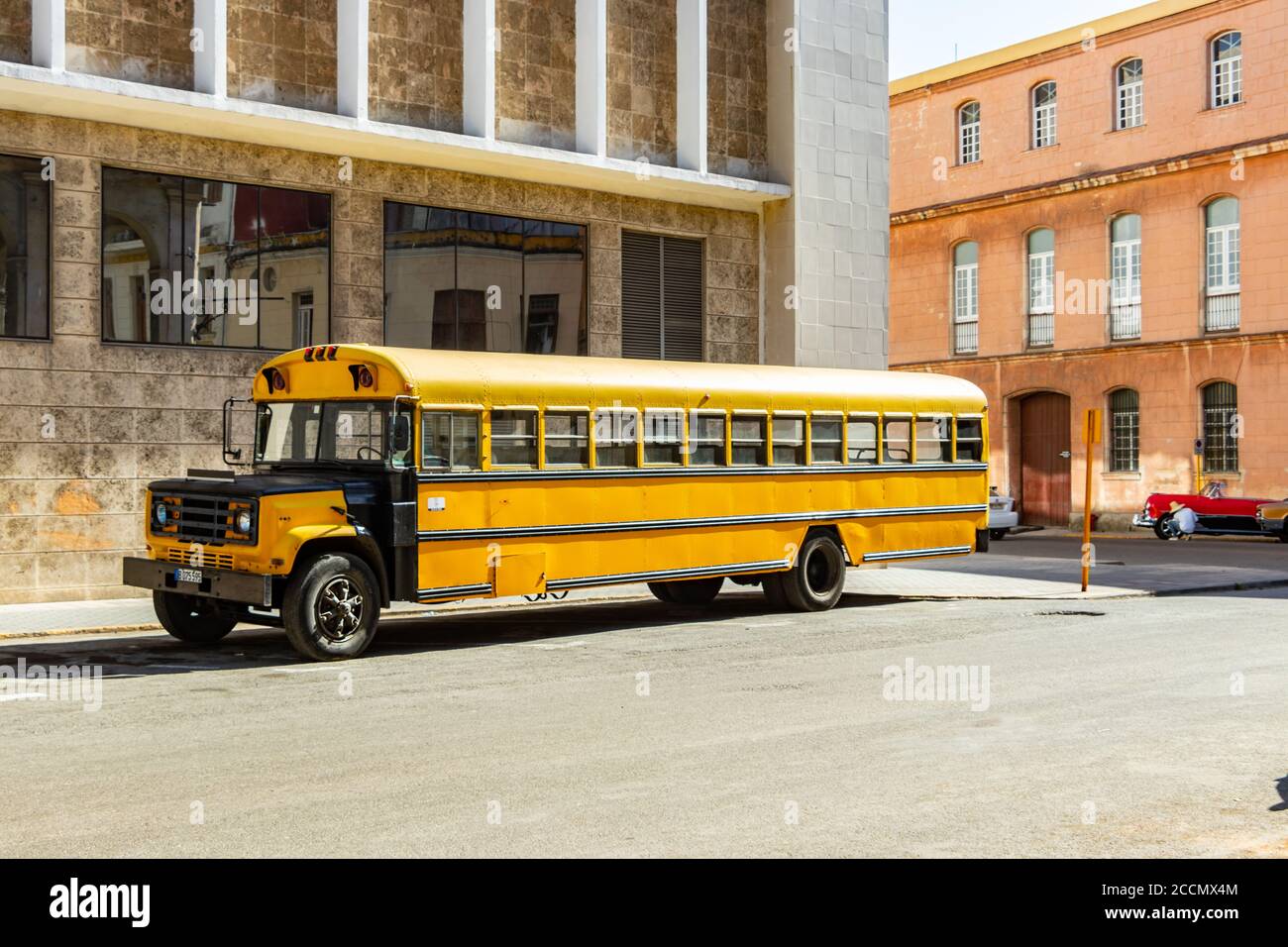 long wheelbase yellow school bus in Havana street cuba Stock Photo