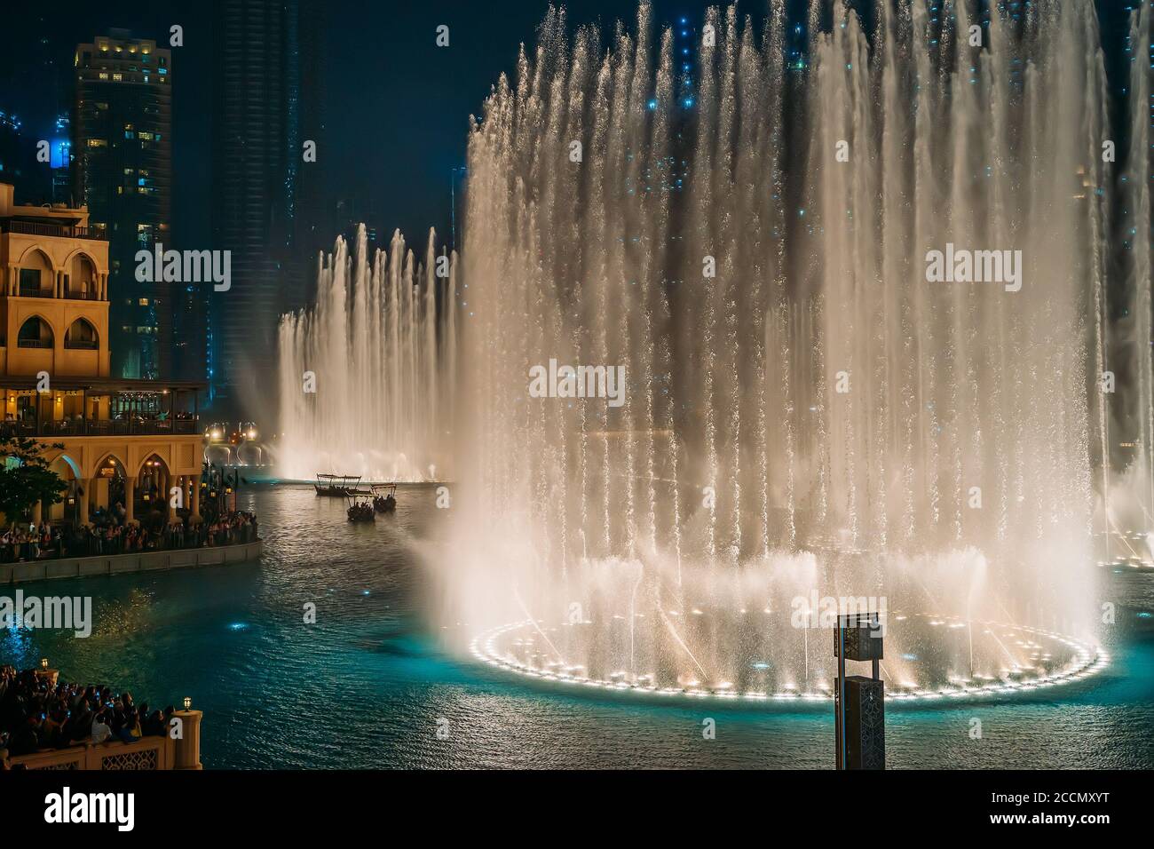 Dancing fountain show in Dubai center in evening, UAE. Tourist attraction. Stock Photo