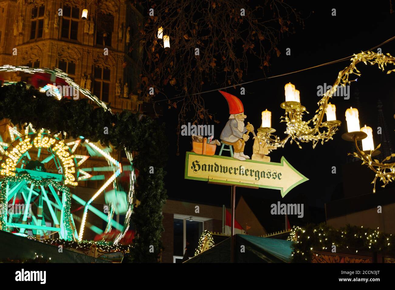Night atmosphere and selective focus at Santa Claus sign over illuminate stalls at Heumarkt, famous Christmas market square in Köln, Germany. Stock Photo