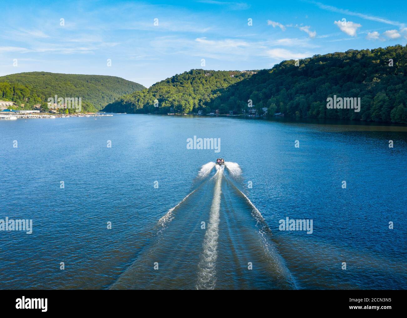 Speedboat sailing down Cheat Lake near Morgantown in West Virginia from aerial drone shot above the water Stock Photo