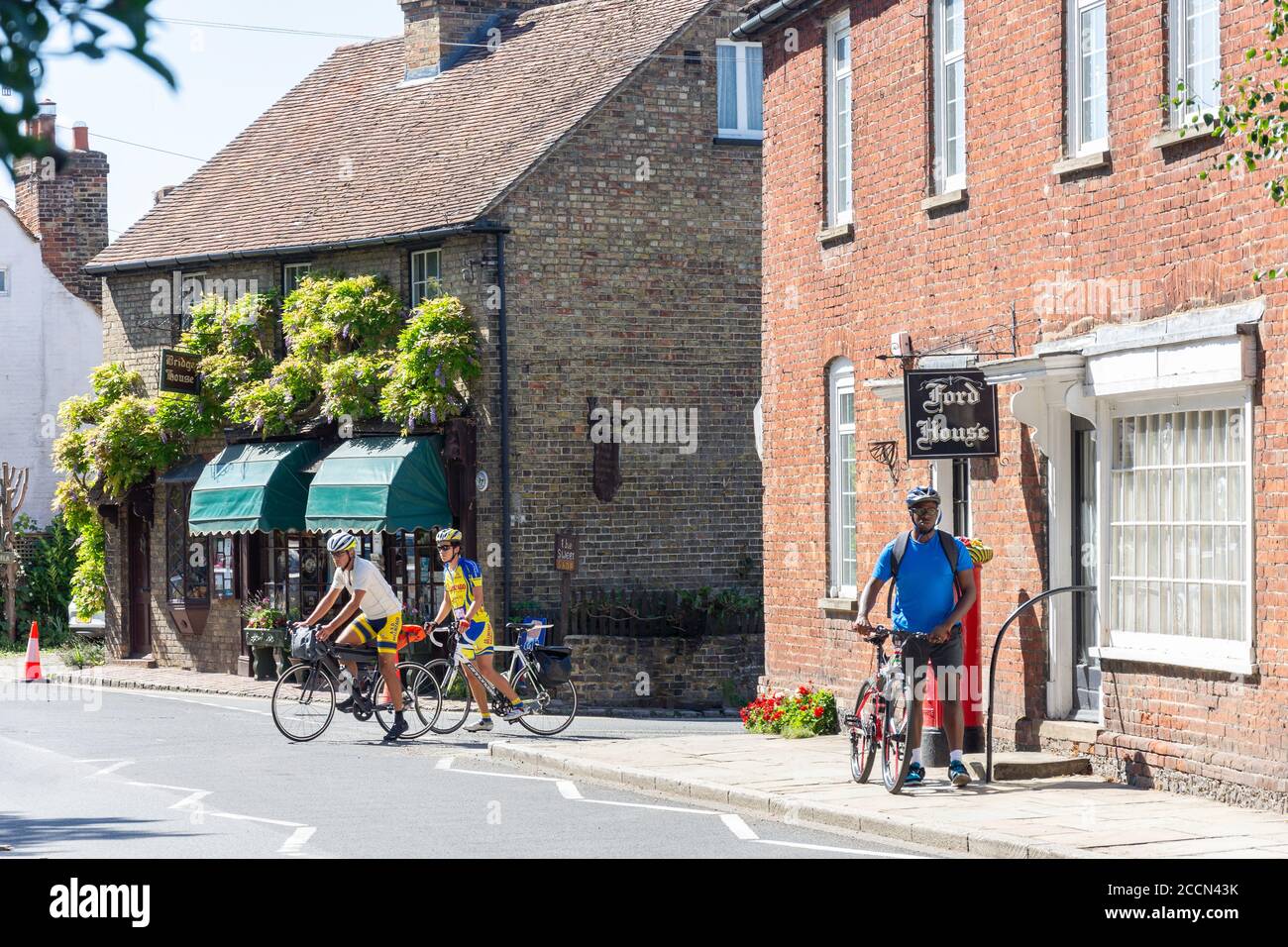 Cyclists on High Street, Eynsford, Kent, England, United Kingdom Stock Photo