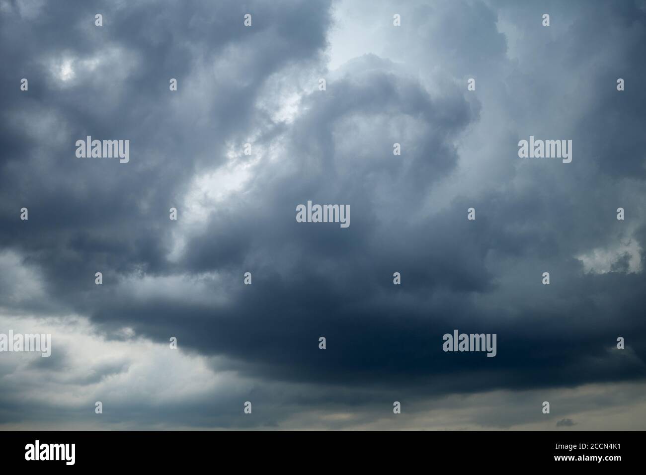 Leaden sky covered with cumulus clouds. Dramatic sky with stratocumulus clouds, occasionally called a cumulostratus Stock Photo