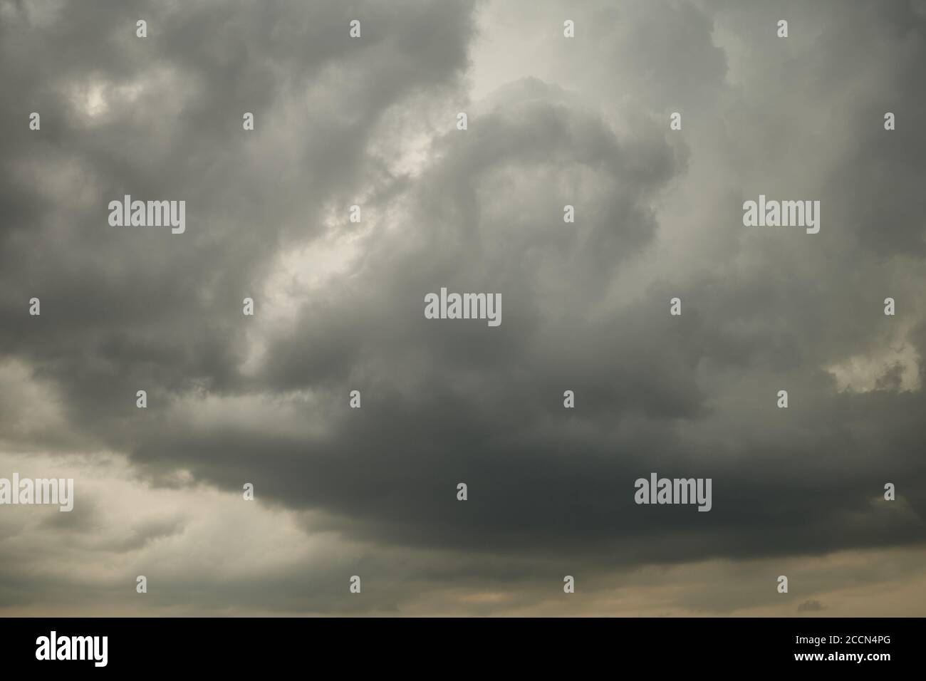 The leaden sky overhead hangs and presses terribly. The gray sky is covered with heavy, leaden clouds. Stock Photo
