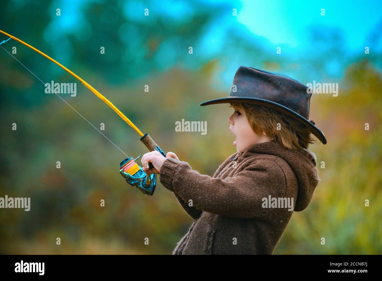 Kid fishing with spinning reel. Kids fly fishing Stock Photo - Alamy