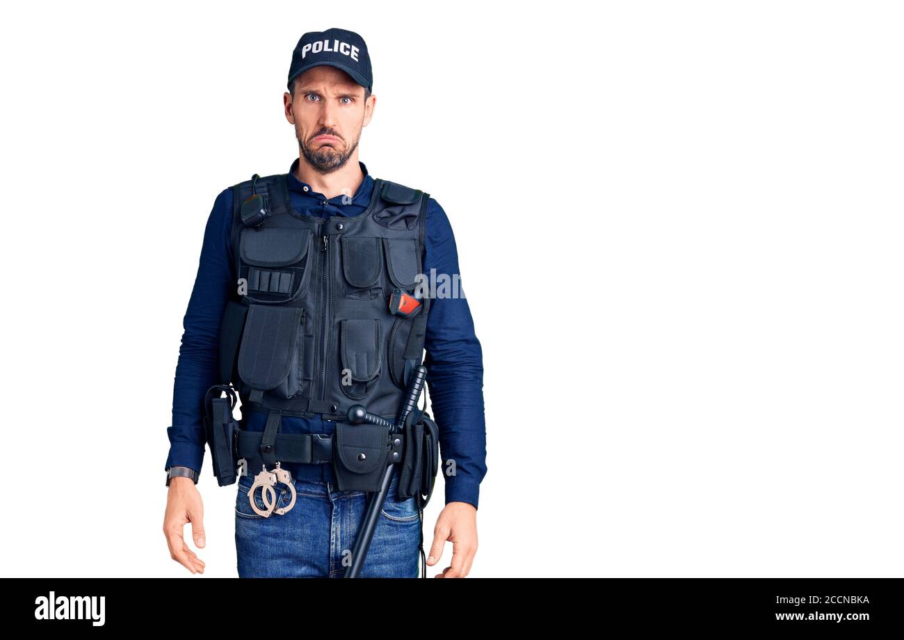 Young handsome man wearing police uniform depressed and worry for distress, crying angry and afraid. sad expression. Stock Photo
