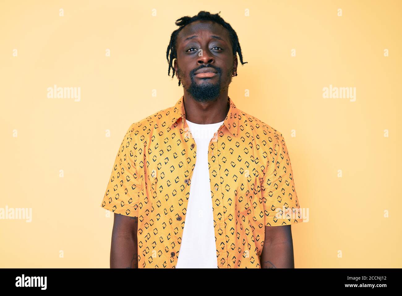 Young african american man with braids wearing casual clothes relaxed ...