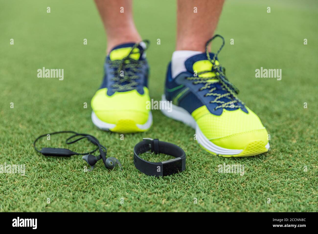 Fitness sport wearable devices man wearing running shoes with wireless