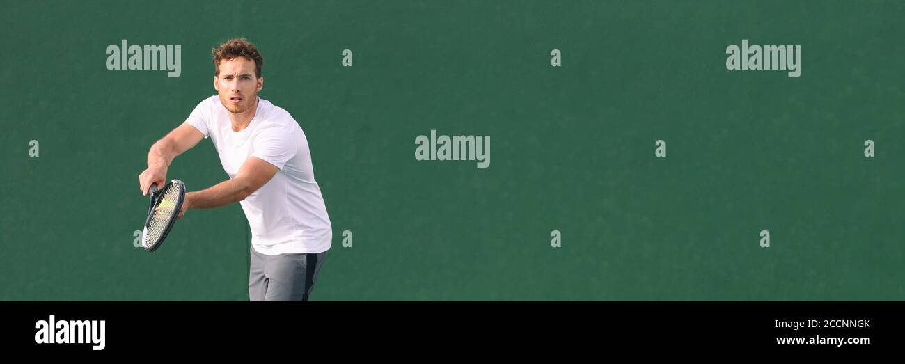 Tennis sport fitness man focused on serve at game. Male athlete tennis player. Concentration in sports. Panorama banner on green background Stock Photo