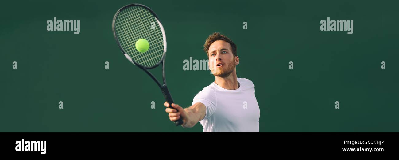 Tennis player man hitting ball playing tennis match on outdoor hard court in fitness club. Male sport athlete healthy lifestyle. Banner crop with copy Stock Photo