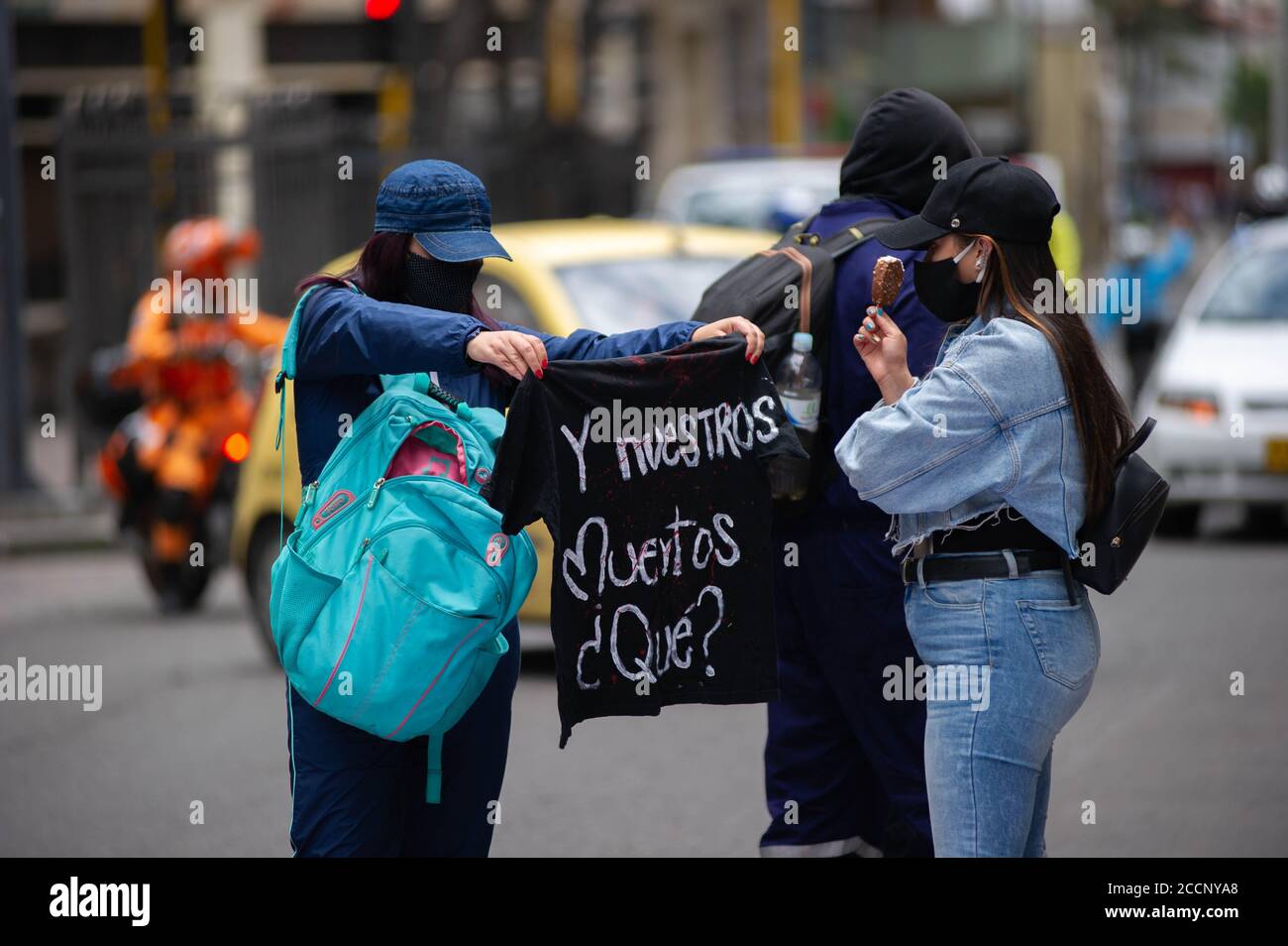 Bogota, Colombia. 23rd Aug, 2020. A demonstrator holds a t-shirt whit a message that reads in spanish 'And our deceased?' during the memorial demonstrations of Dilan Cruz on August 23 2020 in Bogota, Colombia. Dilan Cruz was a high school student who was shot by a riot police officer during the 2019 national strike in Colombia, on the demonstrations that took place on november 23 2019. (Photo by Sebastian Barros Salamanca/Pacific Press) Credit: Pacific Press Media Production Corp./Alamy Live News Stock Photo