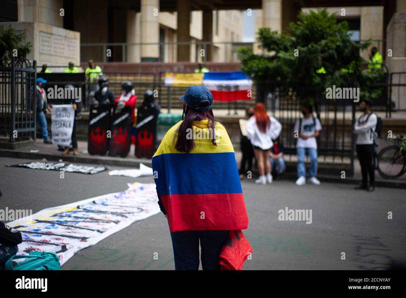 Bogota, Colombia. 23rd Aug, 2020. A demonstrator has a colombian flag wraped on her neck during the Memorial Demonstrations for Dilan Cruz on August 23 2020 in Bogota, Colombia. Dilan Cruz was a high school student who was shot by a riot police officer during the 2019 national strike in Colombia, on the demonstrations that took place on november 23 2019. (Photo by Sebastian Barros Salamanca/Pacific Press) Credit: Pacific Press Media Production Corp./Alamy Live News Stock Photo