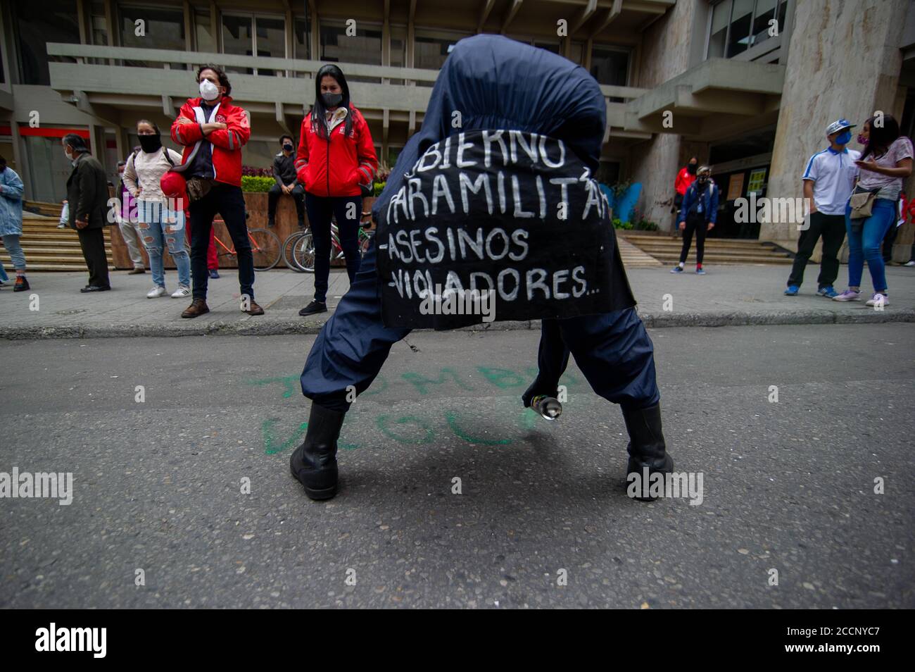 Bogota, Colombia. 23rd Aug, 2020. A demonstrator with a sign strapped to his body that reads in spanish 'Paramilitary Government, assasins and rapists' on August 23 2020 in Bogota, Colombia. Dilan Cruz was a high school student who was shot by a riot police officer during the 2019 national strike in Colombia, on the demonstrations that took place on november 23 2019. (Photo by Sebastian Barros Salamanca/Pacific Press) Credit: Pacific Press Media Production Corp./Alamy Live News Stock Photo