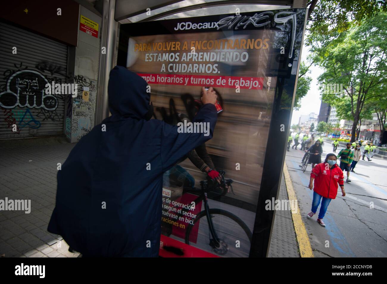 Bogota, Colombia. 23rd Aug, 2020. A demonstrator vandalizes a bus stop during the Memorial Demonstrations for Dilan Cruz on August 23 2020 in Bogota, Colombia. Dilan Cruz was a high school student who was shot by a riot police officer during the 2019 national strike in Colombia, on the demonstrations that took place on november 23 2019. (Photo by Sebastian Barros Salamanca/Pacific Press) Credit: Pacific Press Media Production Corp./Alamy Live News Stock Photo