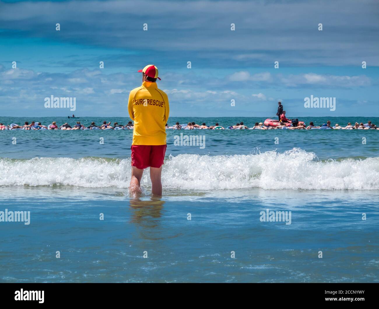 Australian surf lifesaver keeping watch over summer beach crowd Stock Photo