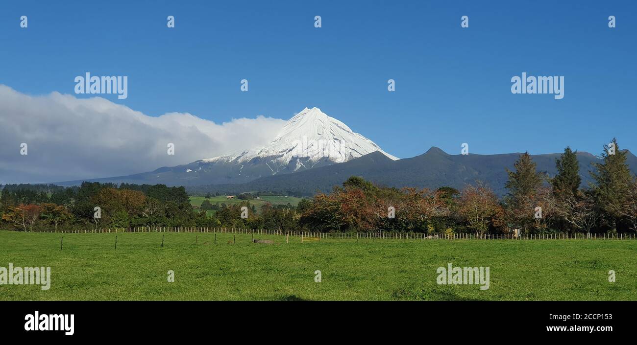 Mount Taranaki New Zealand with farm land in foreground Stock Photo