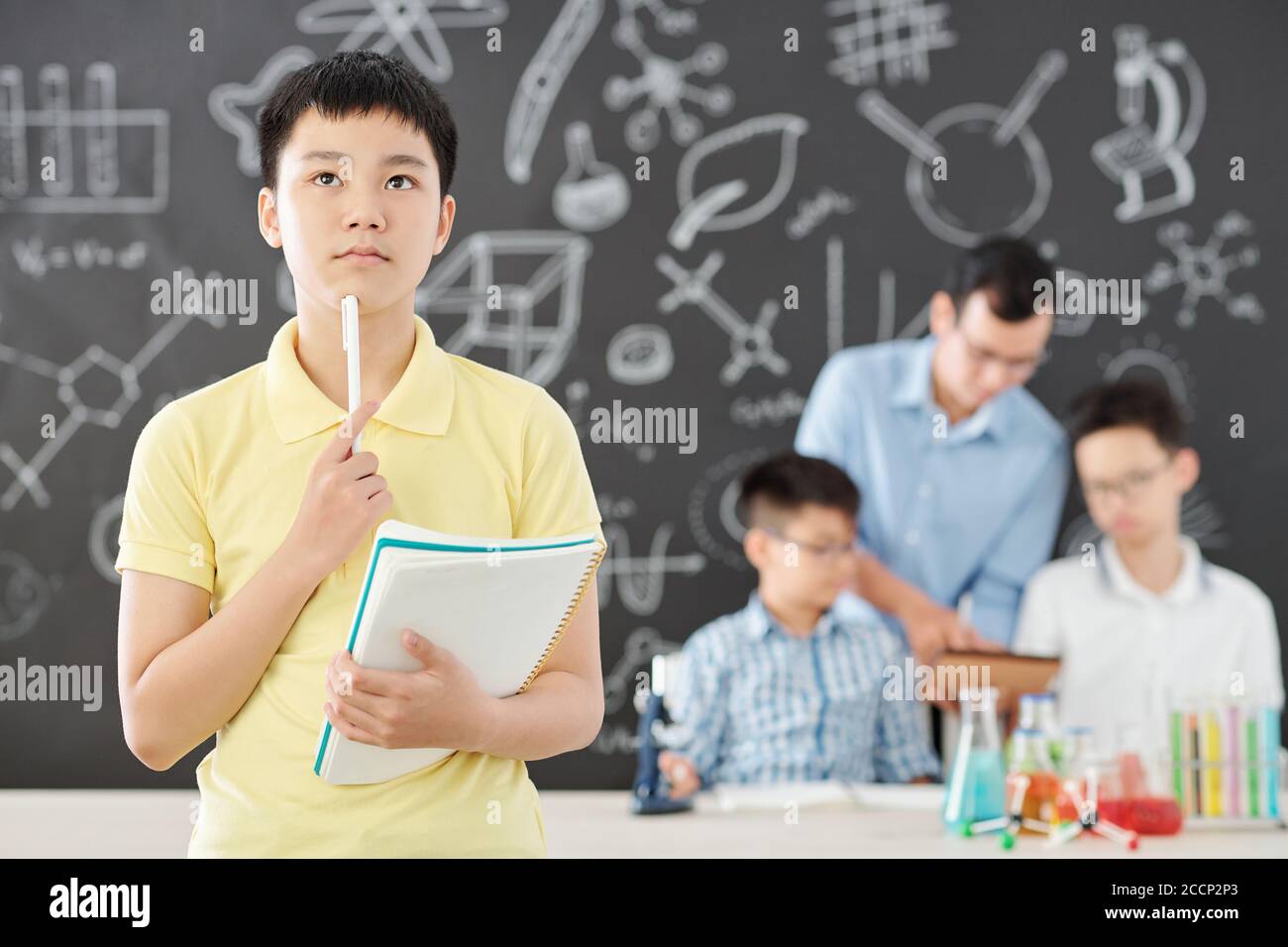 Boy solving chemistry equations Stock Photo