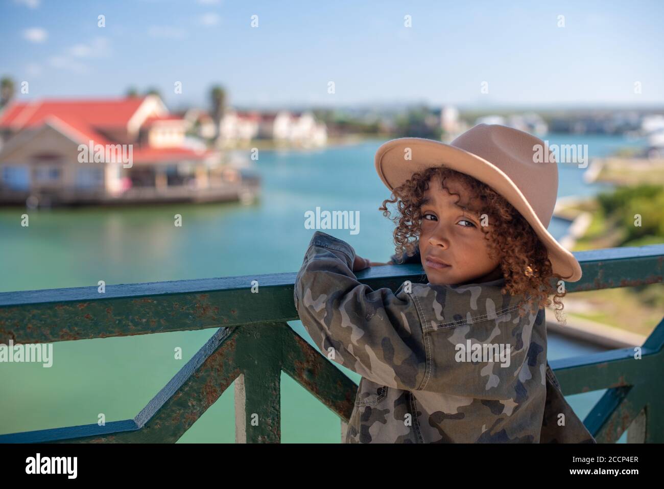 Close up portrait of young boy with hat staring backwards Stock Photo