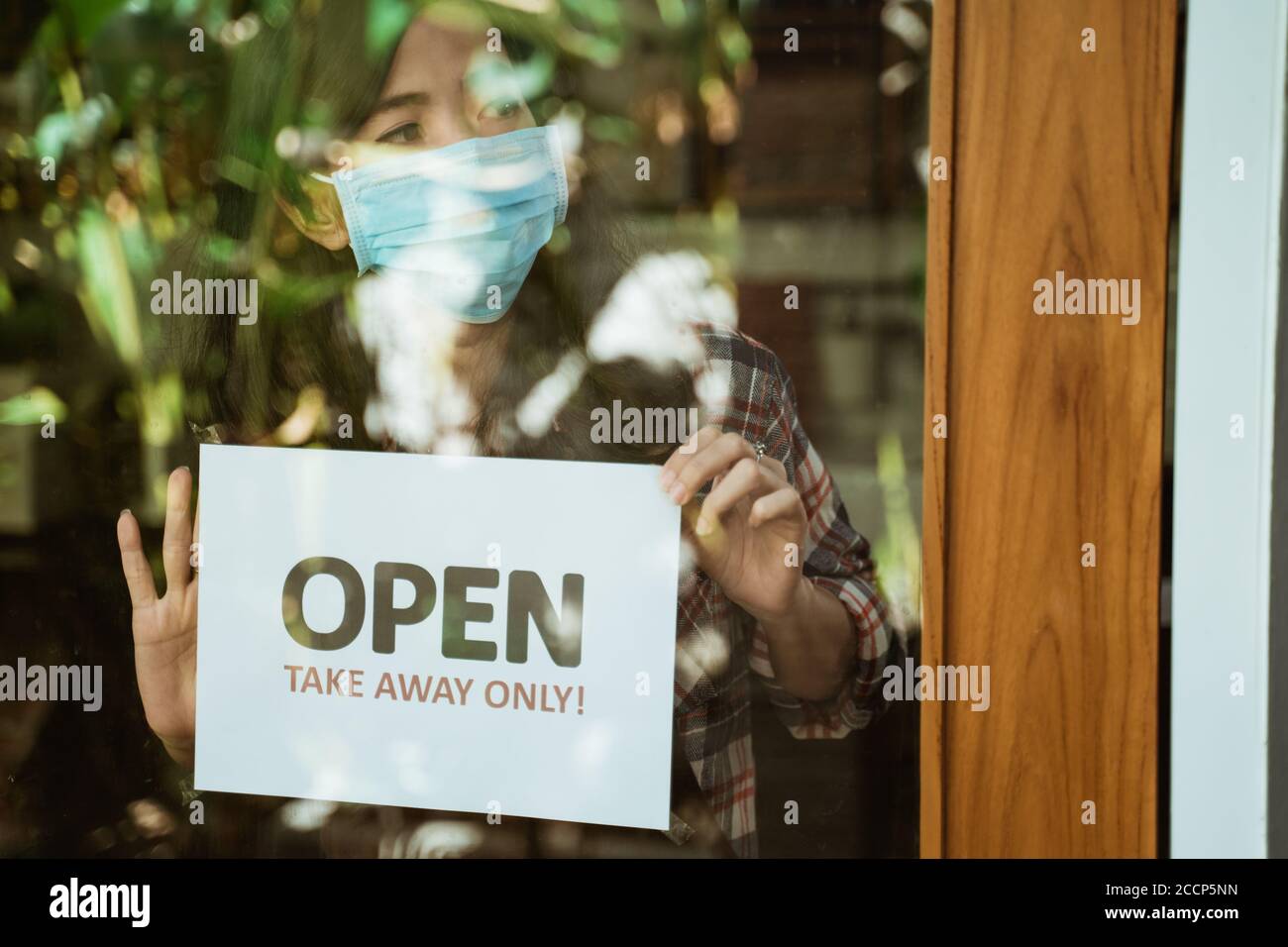 wear masks, keep your distance and wash hand sign on shop front door ...