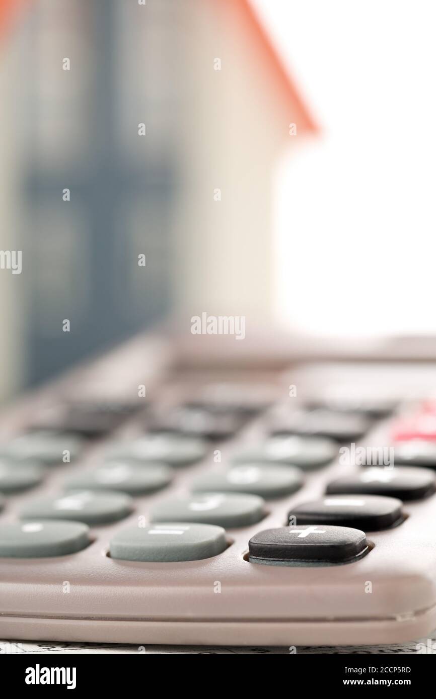 Pocket calculator house model, real estate investment or poroperty costs concept, selective focus Stock Photo