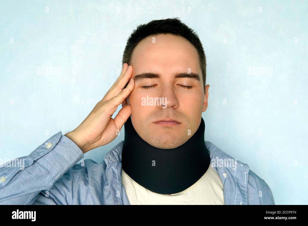 A guy with a bad neck in a black neck collar to stabilize the cervical
