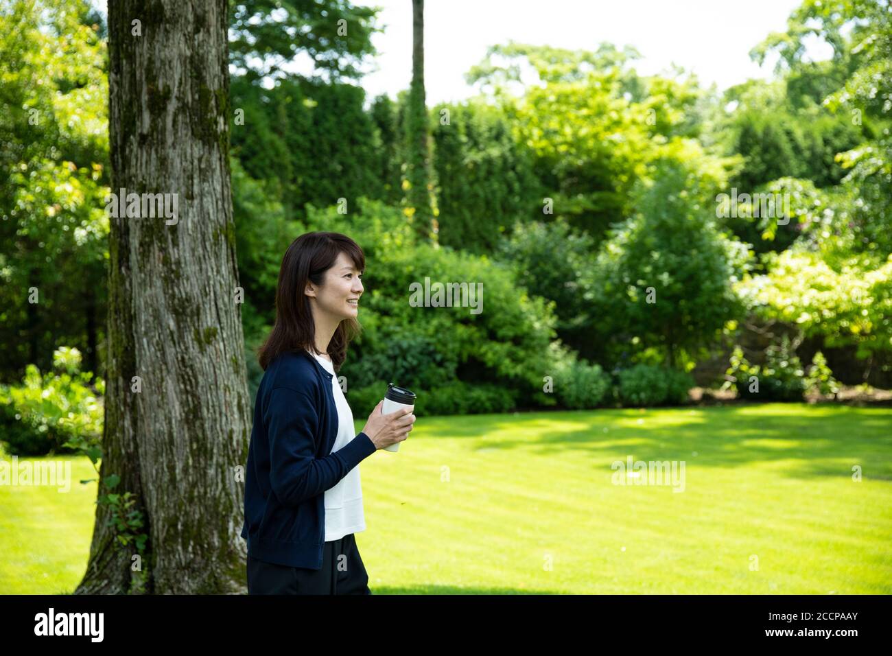 Mature woman relaxing in garden hi-res stock photography and images - Alamy