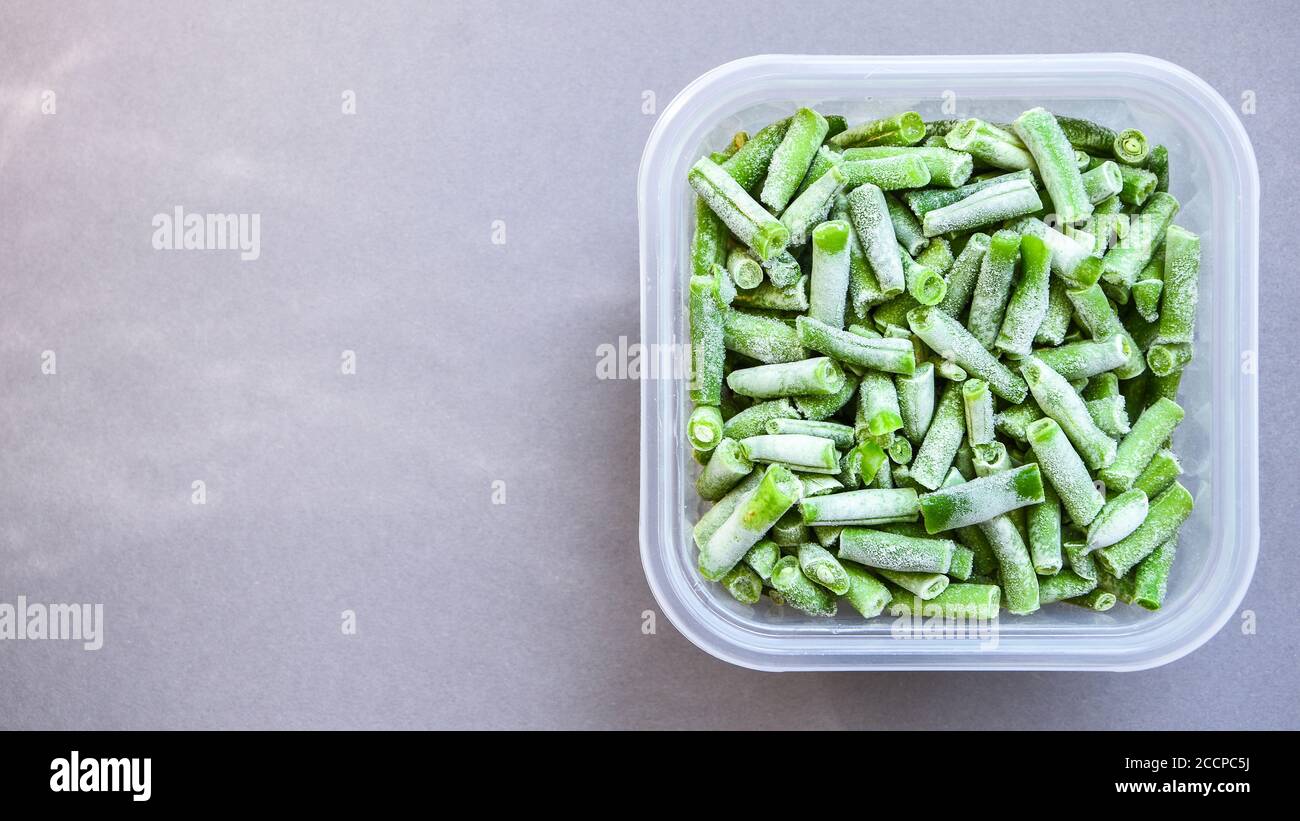 Frozen green beans in a plastic container for longterm storage. Deep